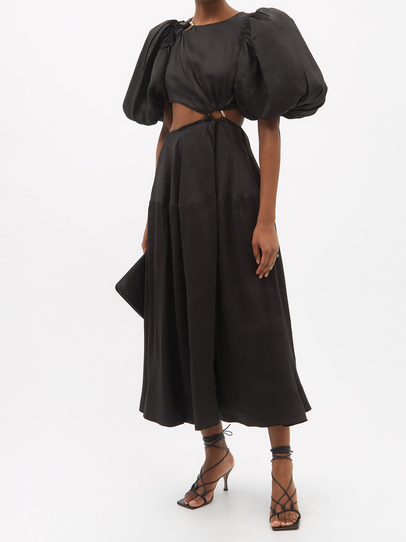 Aje’s black linen-blend midi length dress features short, puffed sleeves and a cutout centre linked with a gold ring at the waist. Round neck with matching smaller gold ring at the collar bone. 