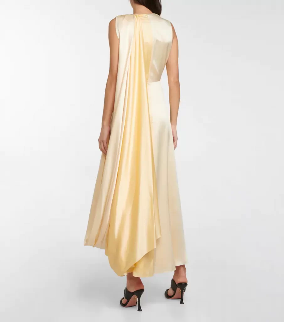 This Pale yellow elegantly draped Nara dress from Roksanda is cut from pure silk with a luxurious, soft handle and is defined by a unique cape detail at the shoulder.
