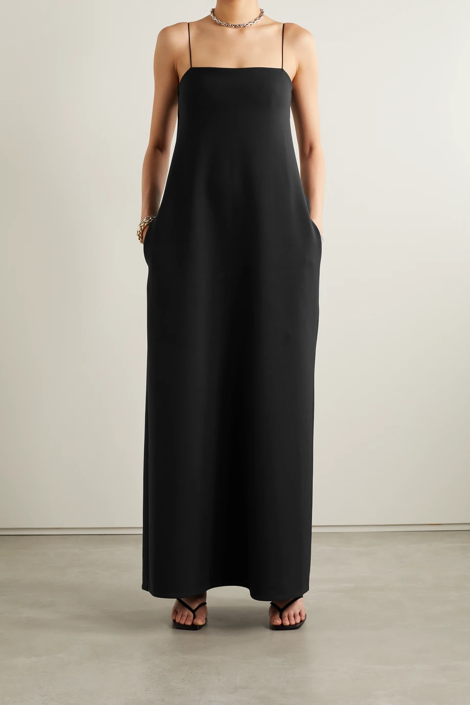 The Row simple and elegant maxi dress cut from smooth, stretchy scuba that skims your frame. Square neckline and thin shoulder straps. 2 hidden side pockets.