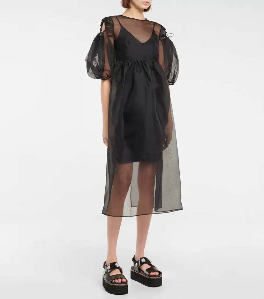 Ethereal silk organza overlay dress from Cecilie Bahnsen. Intended to be layered over a demure base. Mid length, puff sleeves with drawstring peekaboo cut out effect at the shoulder with slender ties. Nipped in under the bust. 