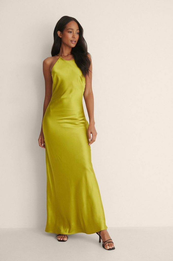 This Chartreuse long satin dress features a high neckline, an open back with thin cross straps, a side zipper, underlining and a flowy fit. 
