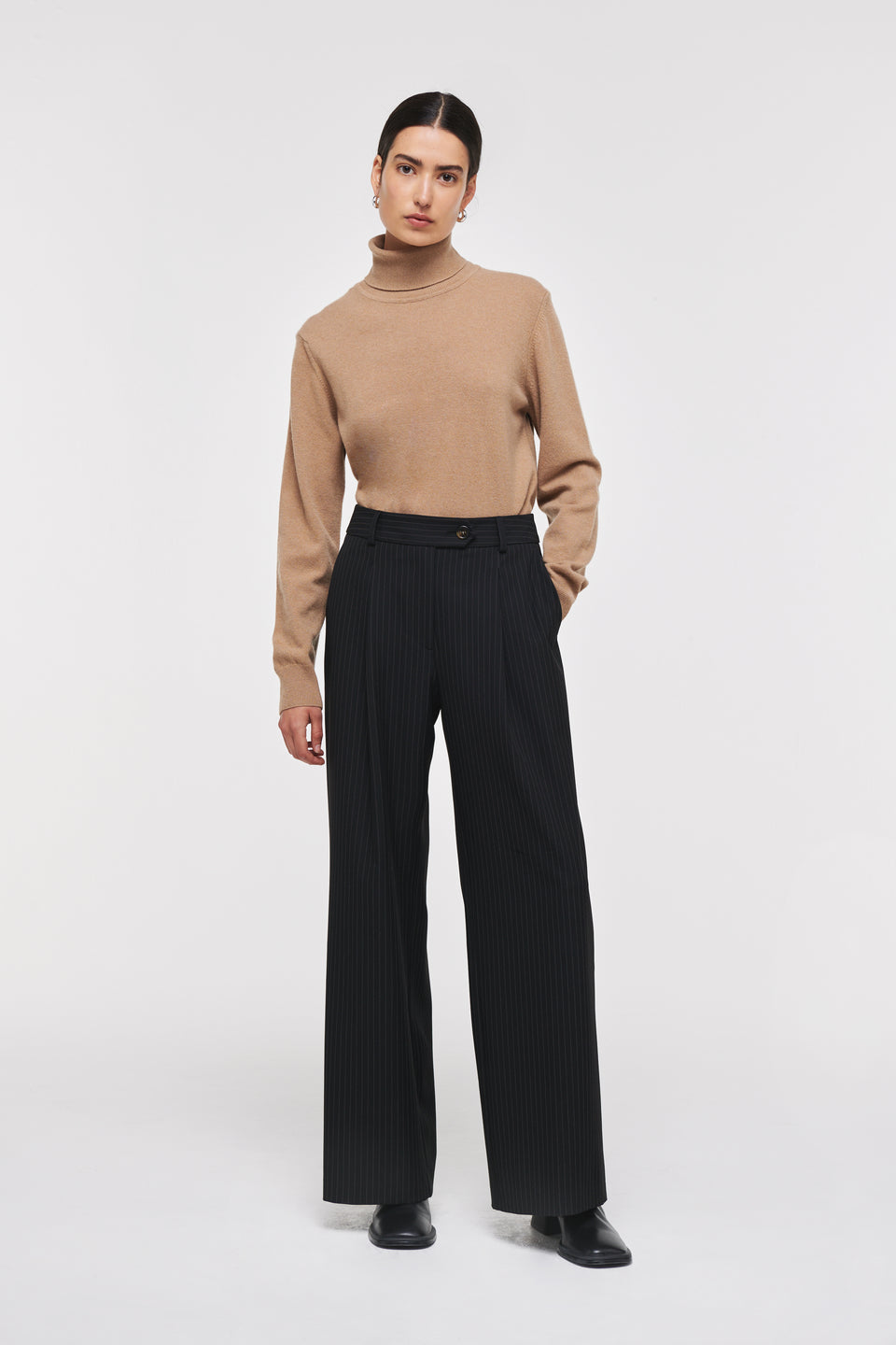 A pair of wide leg tailored trousers are a staple in any wardrobe. Shaped for a fluid silhouette, the design features a mid-rise waist, extended tab waistband and a beautiful black pinstripe pattern. Pair with the matching KIM waistcoat for a statement look.