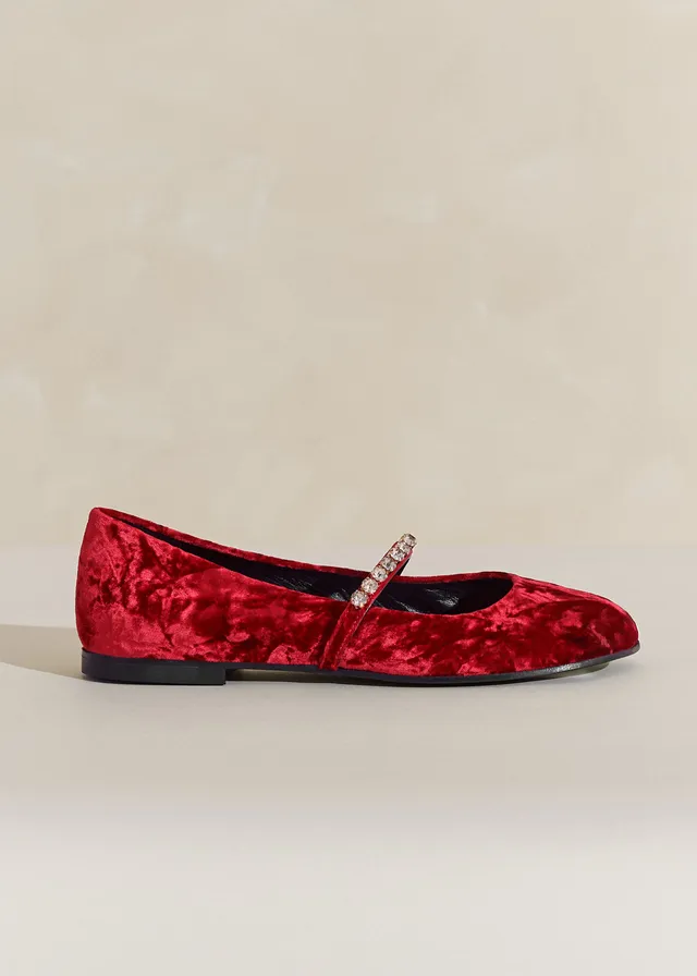 Me + Em Ruby red velvet ballet slippers ready for at-home hosting and dinners that end with dancing. These come in red Italian crushed velvet featuring an embellished elasticated strap.