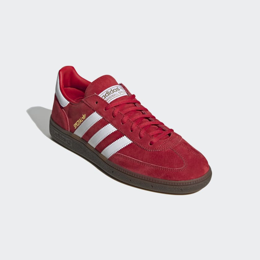 Adidas Originals adidas Handball Spezial Shoes in red. Introduced in 1979, Today, they're a picture-perfect old-school trainer straight out of a vintage ad.