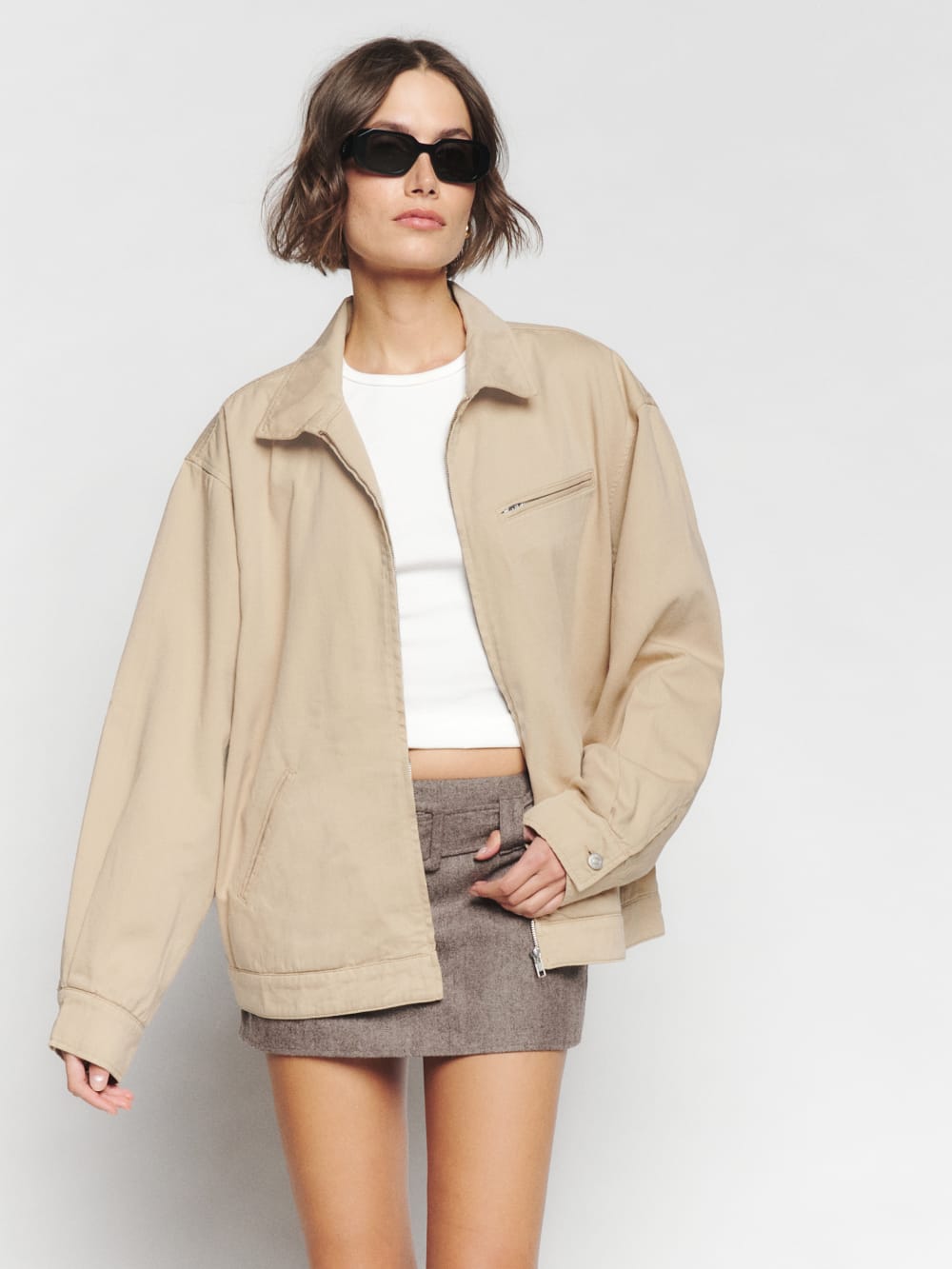 Reformation beige marco bomber jacket. Waist adjustable, chest pockets, welt pockets, and front zipper.