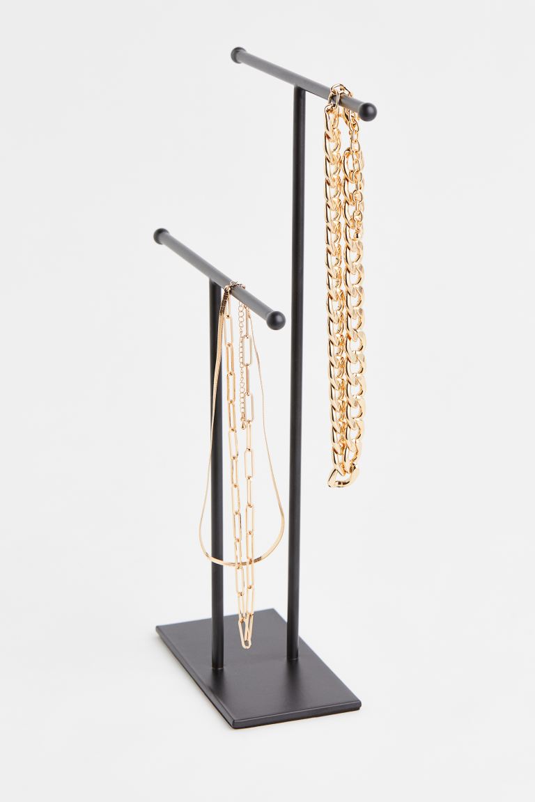Chic Secret Santa Gift Ideas for every budget in 2023. H&M Metal jewellery stand with two T-shaped bars for storing necklaces, bracelets, earrings etc. Rectangular base with padding underneath. Height of the bars 23 cm and 33 cm. Width at the top 20 cm. Width of the base 7.5 cm. Length of the base 14 cm.