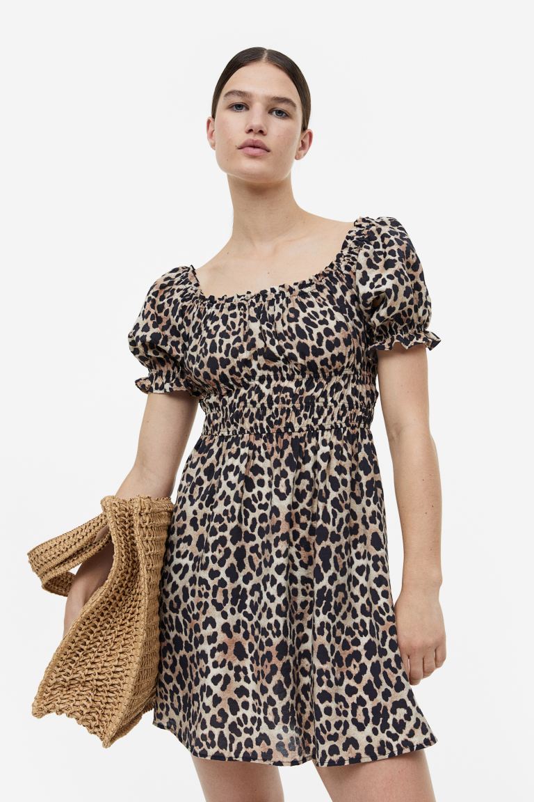 H&M leopard print mini dress. Short off-the-shoulder dress in woven fabric made from a viscose blend. Short puff sleeves and elasticated smocking under the bust and at the waist. Narrow elastication and a small frill trim at the top and cuffs. Unlined.

