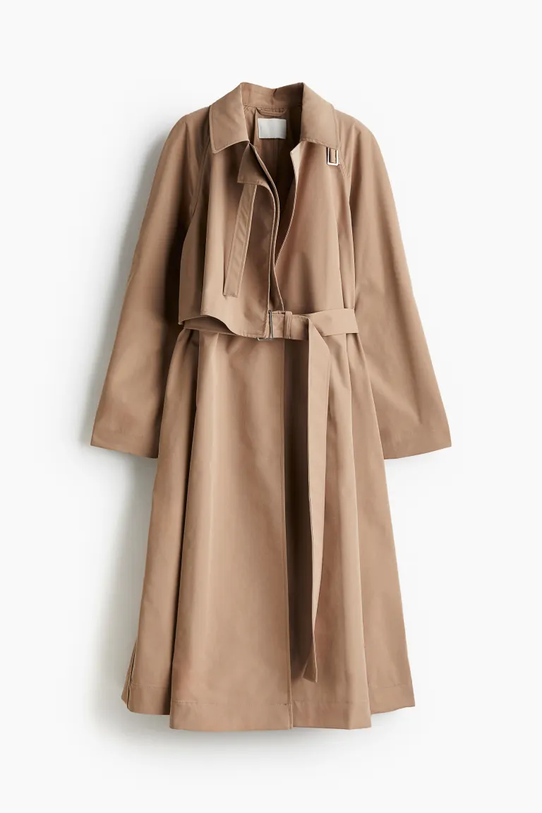 H&M Trench coat in woven fabric with a wrapover front and notch lapels with a tab and buckle. Storm flaps at the front and back, a detachable waist belt with a buckle and discreet side pockets. Long raglan sleeves and a tab with adjustable buttoning at the cuffs. High single back vent. Unlined.
